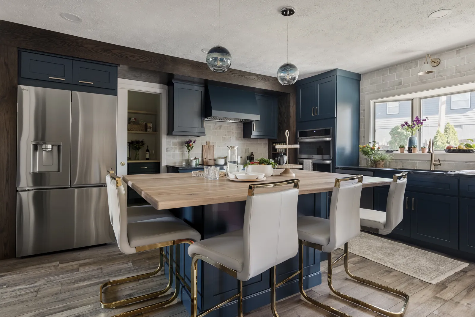 Navy kitchen remodel with butcher block island and counter seating
